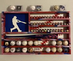 a baseball and bat display in a wooden box with magnets on the wall behind it