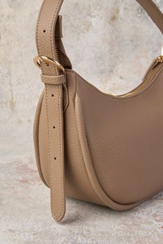 Your new everyday bag is here. Say enchanté to the Sienna Hobo Shoulder Bag. Crafted from vegan leather in Taupe with a soft pebbled look, this half-moon bag is designed to keep all your essentials safe and secure. Versatile Faux Leather Shoulder Bag With Gold-tone Hardware, Versatile Faux Leather Hobo Bag Crossbody, Versatile Faux Leather Crossbody Hobo Bag, Versatile Saddle Bag With Gold-tone Hardware For Everyday, Versatile Faux Leather Bag With Gold-tone Hardware, Faux Leather Saddle Bag With Removable Pouch For Everyday, Everyday Trendy Saddle Bag With Gold-tone Hardware, Trendy Everyday Saddle Bag With Gold-tone Hardware, Textured Faux Leather Crossbody Shoulder Bag