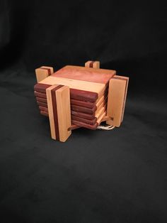 a wooden table and chair made out of pieces of wood on a black background,