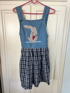 This is so cute! Please note this dress has been cut (not by me) has raw edge, may run short on some. There is plenty of room to physically move buttons on strap see photos. 5.5" left on strap to move buttons if needed  33" length  16"  right under pit to pit  16.5" waist  Ties on back  Sweet carrot button  ✨Please see all photos,measurements and description as I do not accept returns. Best to see all measurements, vintage normally runs small, there are times where it runs generous or true to si Cute Spring Plaid Dress, Fitted Cotton Plaid Dress Casual Style, Casual Cotton Plaid Mini Dress, Casual Gingham Cotton Dress, Casual Cotton Gingham Dress, Cute Sleeveless Cotton Plaid Dress, Casual Sleeveless Cotton Plaid Dress, Cute Plaid Cotton Dress For Spring, Cute Cotton Plaid Dress For Spring