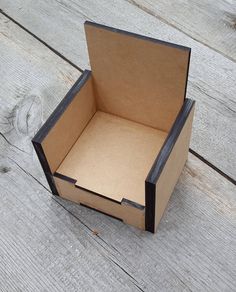 an open cardboard box sitting on top of a wooden floor