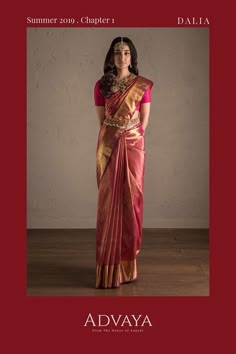 a woman in a red and gold sari with the words advaya written on it