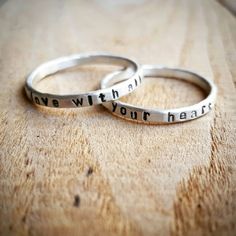 "This personalized hammered ring is hand stamped with the quote or word of your choice. I form these rings from thick sterling silver wire and then hammer them to size. It leaves them with a subtle hammered finish. I then hand stamp the quote onto the rings. They are skinny yet thicker than some of my other name rings. These rings are available in sterling silver or 14K gold and are approximately 2mm wide. In the photos, the rings have a matte finish, but they can also have a shiny or brushed fi Adjustable Engraved Sterling Silver Stackable Rings, Hand Stamped Sterling Silver Stackable Rings For Wedding, Sterling Silver Hand Stamped Stackable Rings For Wedding, Hammered Sterling Silver Engraved Promise Ring, Sterling Silver Hammered Engraved Promise Ring, Hammered Sterling Silver Promise Ring, Inspirational Adjustable Sterling Silver Rings, Adjustable Inspirational Sterling Silver Rings, Meaningful Stackable Engraved Sterling Silver Ring