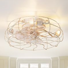 a ceiling light that is hanging from the ceiling in a room with white walls and flooring