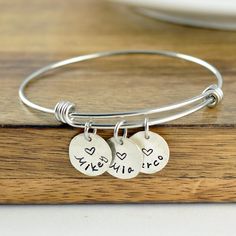 "Personalized Gift, Charm Bracelet, Name Bracelet, Gift for Her, Gift for Mom, Mothers Day Gift, Mom Gift, Mom Birthday, Kids Names This listing is for: one bangle bracelet premium stainless steel bangle this is one size fits all. and 1/2\" sterling silver name charms. ♥CONNECT WITH US♥ ✤pinterest.com/luckyhorngifts ✤facebook.com/luckyhorngifts ✤twitter.com/luckyhorngifts ✤instagram.com/luckyhorngifts" Mother's Day Friendship Charm Bangle Bracelet, Mother's Day Friendship Bangle Charm Bracelet, Handmade Round Charm Bracelet For Birthday, Nickel Free Name Bracelet For Friendship And Mother's Day, Charms Bracelet For Mother's Day Friendship Gift, Friendship Bracelets With Charms For Mother's Day, Charms Bracelet For Birthday And Mother's Day Gift, Nickel-free Name Bracelet For Mother's Day, Charms Bracelets For Mother's Day Birthday Gift