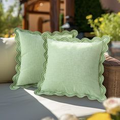 two green pillows sitting on top of a couch