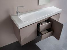 a bathroom sink with an open drawer underneath it