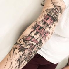 a woman with a lighthouse tattoo on her arm