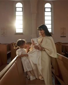 a woman holding a baby in a church