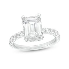 an emerald - cut diamond ring with pave set shoulders