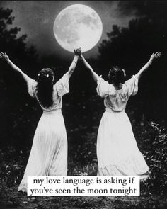 two women in white dresses holding their hands up with the moon behind them and text that reads, my love language is asking if you've