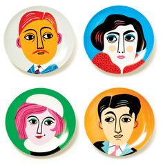 four plates with different faces on them, each painted in different colors and shapes to resemble people's faces