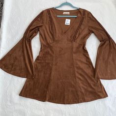 Urban Outfitters Brown Brush Suede Dress With Crochet Trim With Bell Sleeves. This Dress Is Nwt Never Worn And Kept In Plastic. This A Dress That Would Really Look Cute With The Right Boots. This Dress Looks And Has The Feel Of Suede You Won't Be Disappointed. Fitted V-neck Mini Dress By Urban Outfitters, Urban Outfitters Fitted V-neck Mini Dress, Bohemian Fitted Mini Dress With Bell Sleeves, Urban Outfitters V-neck Mini Dress For Brunch, Fitted Urban Outfitters Mini Dress For Fall, Fitted Mini Dress By Urban Outfitters For Fall, Urban Outfitters Fitted Mini Dress For Fall, Casual Urban Outfitters Dress For Fall, Urban Outfitters Casual Fall Dress