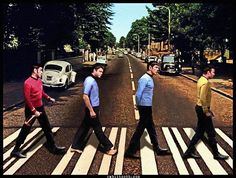 the beatles crossing the street in front of an old car