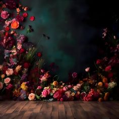 an artistic photo with flowers on the floor and in the background is a dark sky