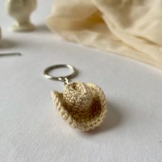 a crocheted keychain with a small hat on it's end