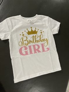 This beautiful t shirt is made to order. This  T shirt is made with a beautiful gold glitter and a soft pink vinyl. White Custom Print T-shirt For Party, Pink Glitter Print Short Sleeve T-shirt, Pink T-shirt For Birthday, Pink Glitter Print Top For Birthday, Pink Birthday T-shirt With Name Print, Cute Birthday T-shirt, Pre-shrunk, Pink T-shirt With Name Print For Birthday, Pink Graphic Tee For Birthday, Gold Graphic Print Top For Birthday