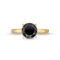 a black diamond engagement ring with two yellow gold accents on the band and an oval cut stone