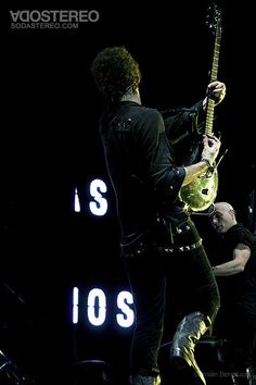 a man playing an electric guitar on stage