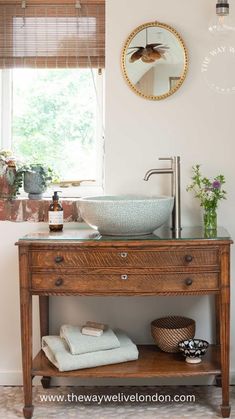 a bathroom with a sink, mirror and towel rack next to a radiator