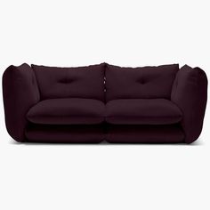 a purple couch sitting on top of a white floor