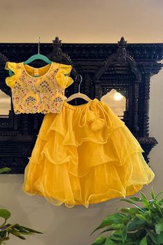 Yellow attached can  ruffle and layered lehenga. Paired with a blouse with all over resham and aari floral embroidery.
Components: 2
Pattern: Embroidery
Type Of Work: Resham, Floral, Aari
Neckline: Round Neck
Sleeve Type: Short Sleeves
Fabric: Organza, Cotton Silk, Mulmul
Color: Yellow
Other Details: 
Ruffle ornamented latkan on lehenga
Occasion: Festive and Wedding - Aza Fashions Layered Lehenga, Baby Lehenga, Langa Blouse, Mom Daughter Matching Dresses, Lehenga With Blouse, Kids Party Wear Dresses, Lehenga Design, Child Dress, Organza Embroidery