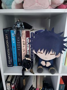 a book shelf filled with books and stuffed animals