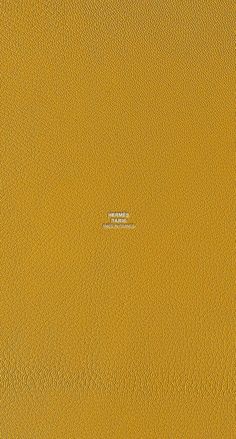 a yellow leather textured surface with the word,