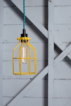 a yellow cage light hanging from the ceiling