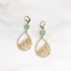 "Turquoise Chandelier Earrings. Dangle Earrings. Statement Earrings. Jewelry Gift. Modern Fashion Drop Earrings. Chandelier Earrings Gift. The gold pendants are are matte gold plated pewter and measure 30mm x 40mm. The faceted glass jewels are 8mm. The earrings dangle about 2\". See all our Fashion Earrings here https://www.etsy.com/shop/RusticGem?ref=seller-platform-mcnav&section_id=11244346 Rustic Gem Shop https://www.etsy.com/shop/RusticGem?ref=seller-platform-mcnav These earrings are fun Elegant Turquoise Teardrop Earrings For Party, Elegant Turquoise Chandelier Drop Earrings, Elegant Turquoise Teardrop Earrings, Elegant Turquoise Teardrop Pierced Earrings, Elegant Turquoise Dangle Chandelier Earrings, Turquoise Chandelier, Unique Chandeliers, Earrings Chandelier, Gold Pendants