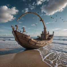 an old wooden boat sitting on top of a sandy beach