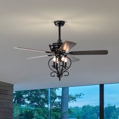 a ceiling fan with three lights hanging from it's blades in a living room