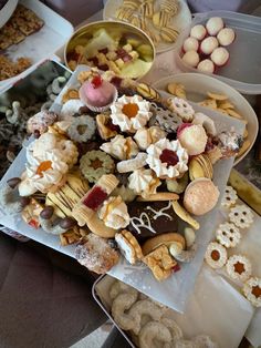 a table topped with lots of different types of snacks and desserts next to each other