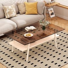 a living room with a couch, coffee table and books on the shelf next to it