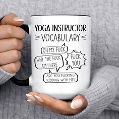 a woman holding a coffee mug with yoga instructor's words on the front and side