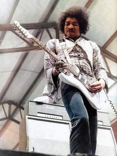 a man with an electric guitar on stage