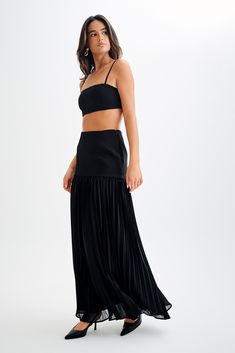 Going with the flow.The JILLIAN Pleated Maxi Skirt is a sophisticated and elegant addition to any wardrobe. This high-waisted skirt features a fitted yoke that transitions into a beautifully pleated chiffon lower skirt, offering a graceful flow and movement. With its maxi length, it exudes timeless charm. Pair it with the Letitia Suiting Halter Top with Buckle for a chic and polished ensemble. Evening Flared Pleated Skirt With Lining, Flared Pleated Skirt With Lining For Evening, Evening Pleated Full Maxi Skirt, Evening Pleated Tiered Lined Skirt, Evening Tiered Pleated Skirt With Lining, Fitted Accordion Pleated Maxi Skirt For Evening, Fitted Dresses With Accordion Pleats, Pleated Flared Maxi Skirt For Evening, Evening Pleated Flared Maxi Skirt