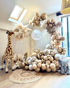 a giraffe standing next to a bunch of balloons