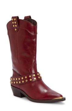 A slim rand and flat studs kick up shine in a Western-inspired boot outfitted with a low stacked heel. 1 1/4" heel 9" shaft Pull-on style Leather upper/synthetic lining/rubber sole Imported Fitted Studded Boots For Fall, Leather Boots With Gold Studs For Fall, Fitted Studs Boots For Fall, Western Studs Boots For Fall, Western Style Boots With Rivets For Fall, Fall Snip Toe Boots With Spikes, Western Style Studded Heeled Boots For Fall, Fall Spiked Snip Toe Boots, Western Heeled Boots With Studs And Round Toe