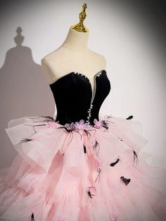 Make a glamorous statement at your next soirée with our Black and Pink Tulle Party Dress, a spectacular ensemble that perfectly marries boldness with elegance. This striking gown features a luxurious black velvet bodice that gracefully transitions into a vibrant pink tulle skirt, setting a dramatic and fashionable tone. Adorned with charming pink floral accents, the skirt brings a playful and romantic flair to the design. A dazzling crystal-embellished waistline draws the eye, accentuating your curves with sophistication. Ideal for upscale parties or as a distinctive choice for an evening gown, this dress ensures that all eyes will be on you. Step into the night with confidence and style in this exquisite pink evening gown, tailored to celebrate plus-size beauty. Gunne Sax Wedding Dress, Goth Characters, Victorian Style Wedding Dress, Dresses Sweet 16, Pink Evening Gowns, Cute Dresses For Women, Strapless Ball Gown, Nontraditional Wedding Dress, Sweet 15 Dresses