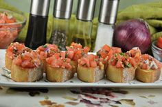 small appetizers are arranged on a white platter next to other food items