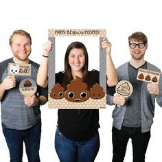 three people are holding up pictures and posing for the camera while one person is holding a sign