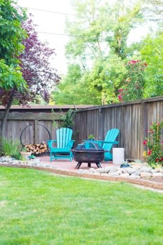 a backyard with two chairs and a fire pit