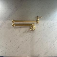 two brass handles on a marble counter top