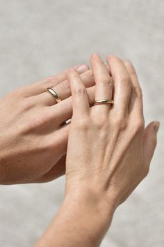 The Tourne Ring is our first wedding band offering to our core collection. Each band is thoughtfully crafted in recycled gold, available in white or yellow, in 14k or 18k. Our intention while designing the Tourne Ring was to create a piece that felt luxurious and significant. Each band has a beautiful heft to it, comfortable, but a subtle reminder of the connection to your beloved. With a gentle, rounded form on the outside, and a soft finish on the inner edge for comfort, the Tourne Ring is an updated version of a timeless classic. Details: Available in solid 14k and 18k gold. Gold is 100% recycled. Engraved with maker's mark and fineness mark at interior. Ring is 4.75 mm in height. Ring is 3 mm thick. Ring is around 10 grams in 14k and 11.5 grams in 18k. All of our jewelry is made indivi Minimalist Wide Band Ring With Polished Finish For Wedding, Minimalist Rings With Timeless Design For Gift, Minimalist Timeless Rings As Gift, Minimalist Timeless Design Rings As Gift, Timeless 14k Gold Wedding Ring, Minimalist White Gold Signet Promise Ring, Timeless Thick Band Wedding Ring, Timeless 14k Wedding Ring, Fine Jewelry Signet Ring With Thick Band For Wedding