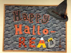 a sign that says happy hallo - o - read with a witches hat on top