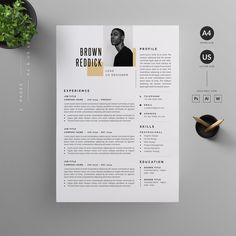 a clean and modern resume template on a desk with a plant next to it,