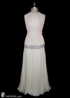 a white dress on display in front of a black background