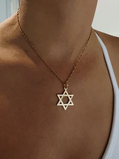 Celebrate your Jewish identity with this beautiful 14K yellow gold Magen David necklace. Jewish pride doesn't go out of style and neither does this classic necklace. Star Of David Tarnish Resistant Necklace Gift, Minimalist Gold Necklace With Star Of David, Gold Sterling Silver Star Of David Necklace, Classic Star Of David Jewelry For Gift, Symbolic 14k Gold Necklaces Stamped 14k, 14k Gold Pendant Necklace Stamped 14k, Spiritual 14k Gold Clavicle Chain Necklace, Yellow Gold Star Of David Necklace With Polished Finish, Gold Engraved Star Of David Necklace