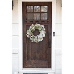 a wooden door with a wreath on it